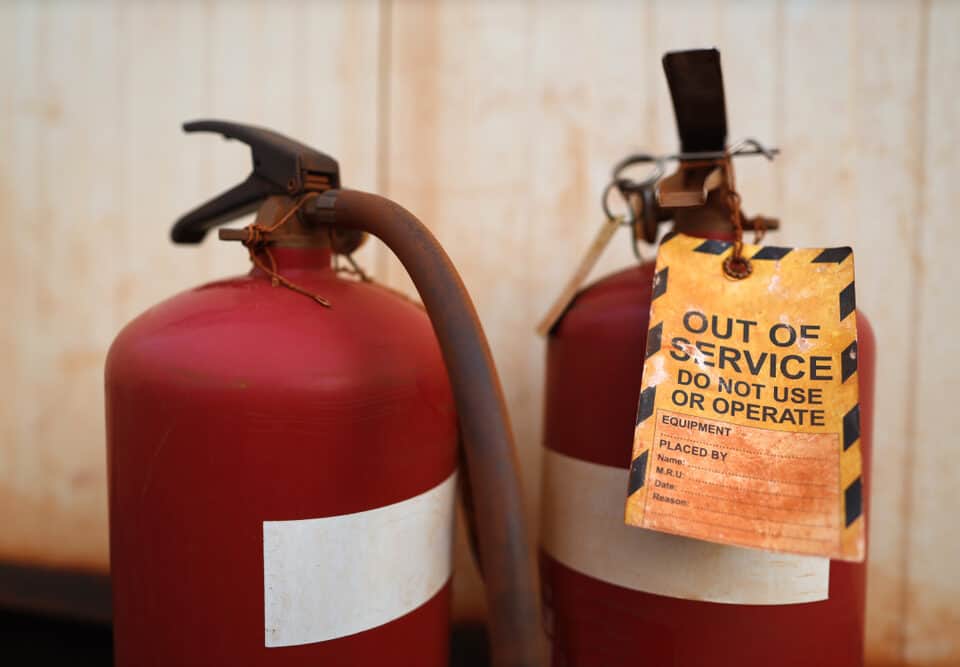 fire extinguisher with out of service tag.
